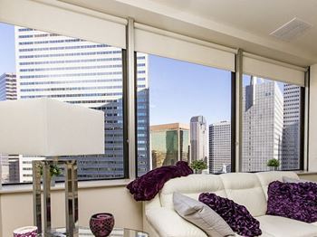 Expansive windows with solar shades overlooking downtown dallas